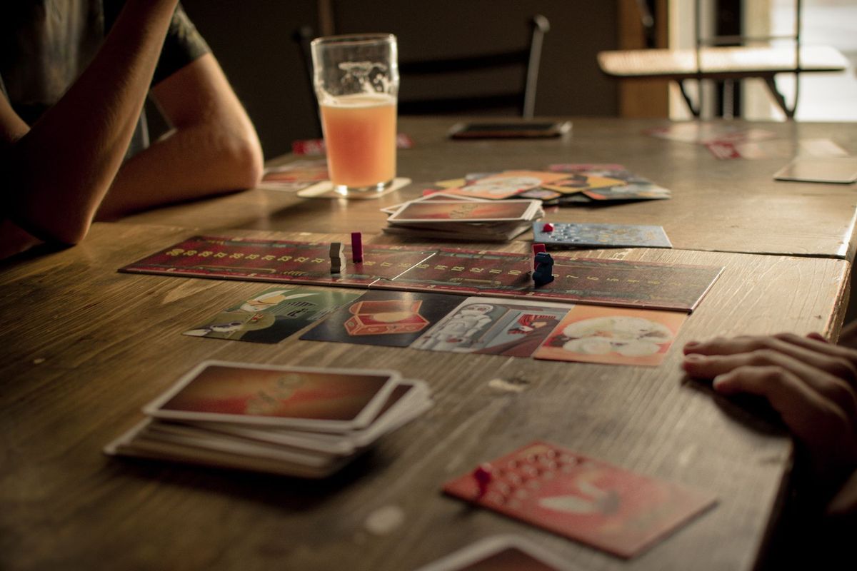 Friends playing at a table with drinks